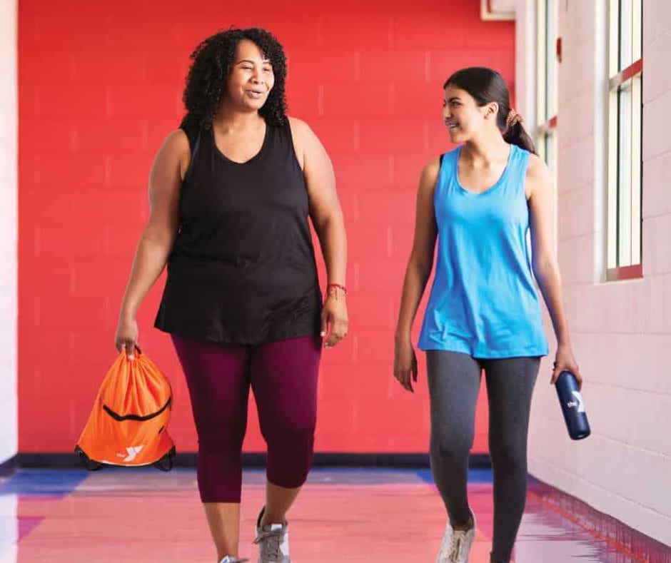 two women walking down a hallway