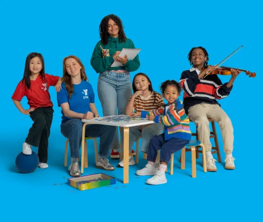 Camp counselor and campers grouped together around a table